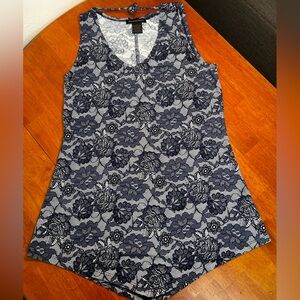 Sleeveless women’s top with blue floral lace pattern.